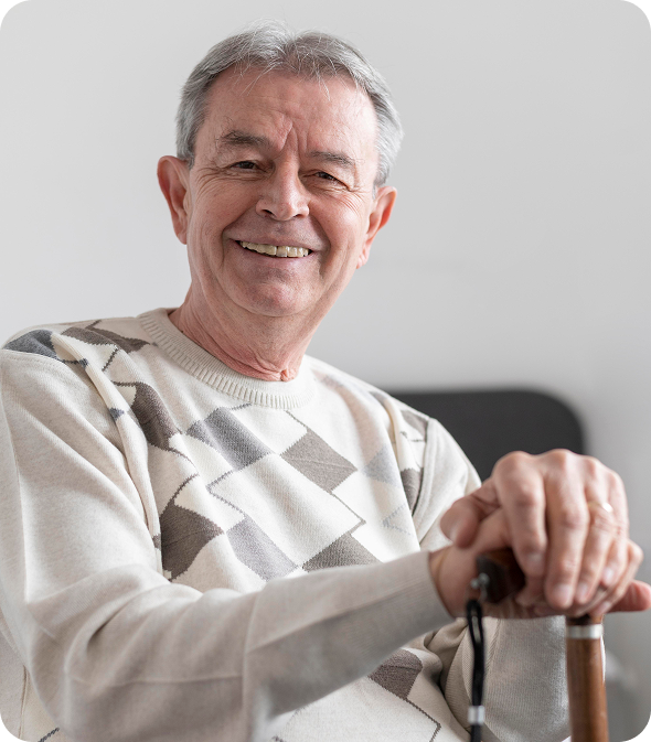 Smiling elderly man with a cane